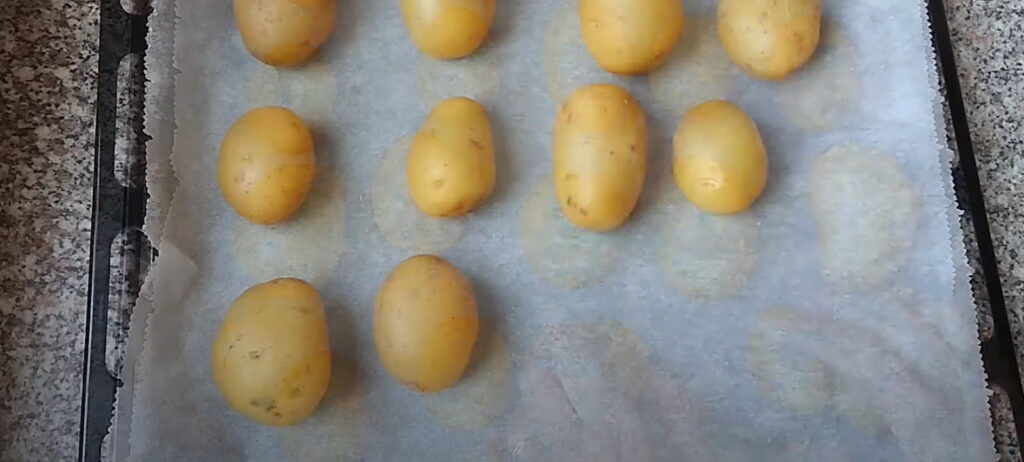 Варена ціла картопля в шкарлупі викладена на деко